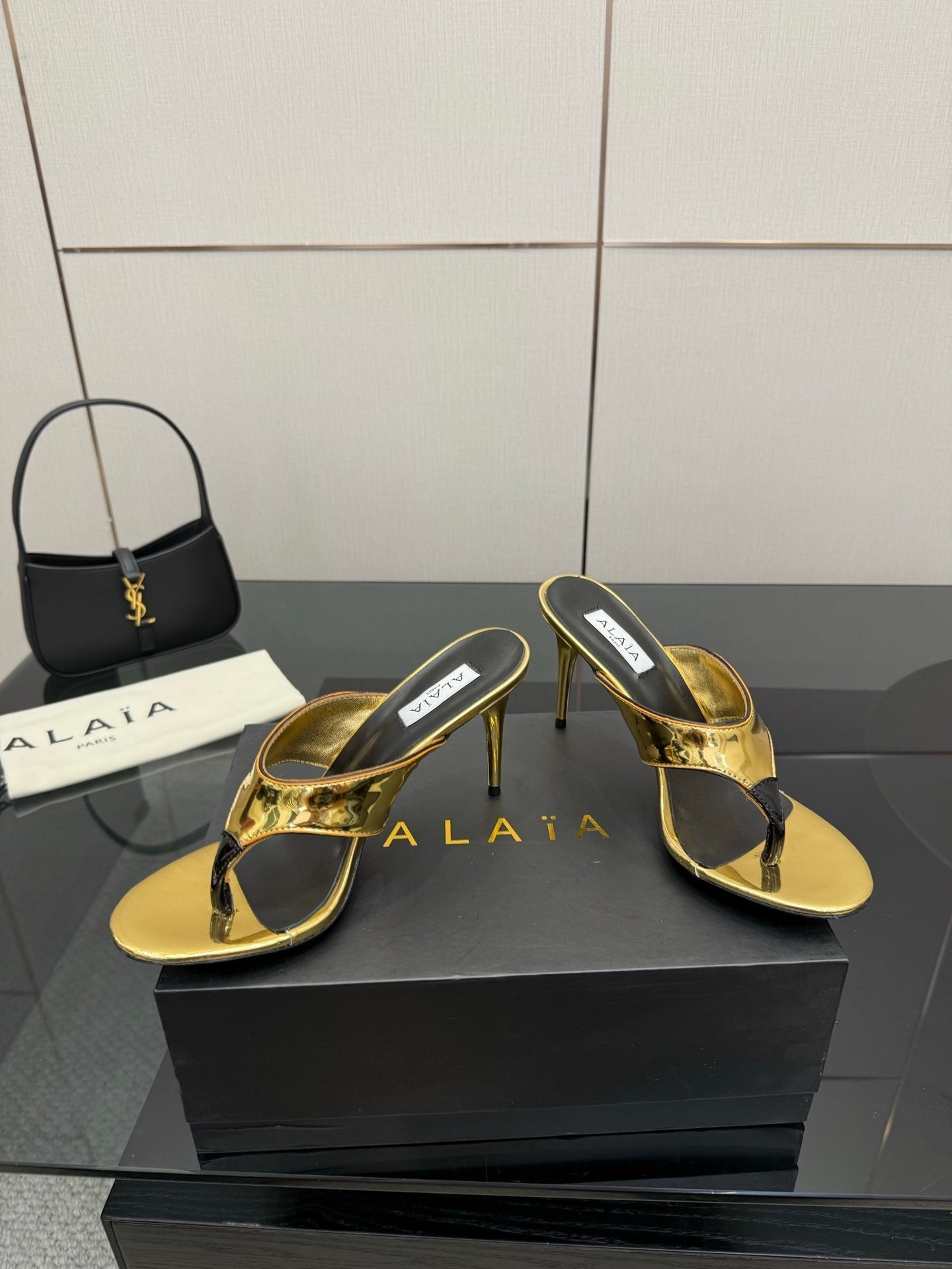 ALAIA HEELED THONG 25S IN GOLD PATENT LEATHER