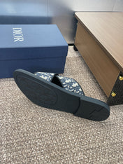 DIOR 25S ALIAS CROSS-STRAP SLIDES IN BLACK CALFSKIN WITH CD OBLIQUE DEEP BLUE LOGO